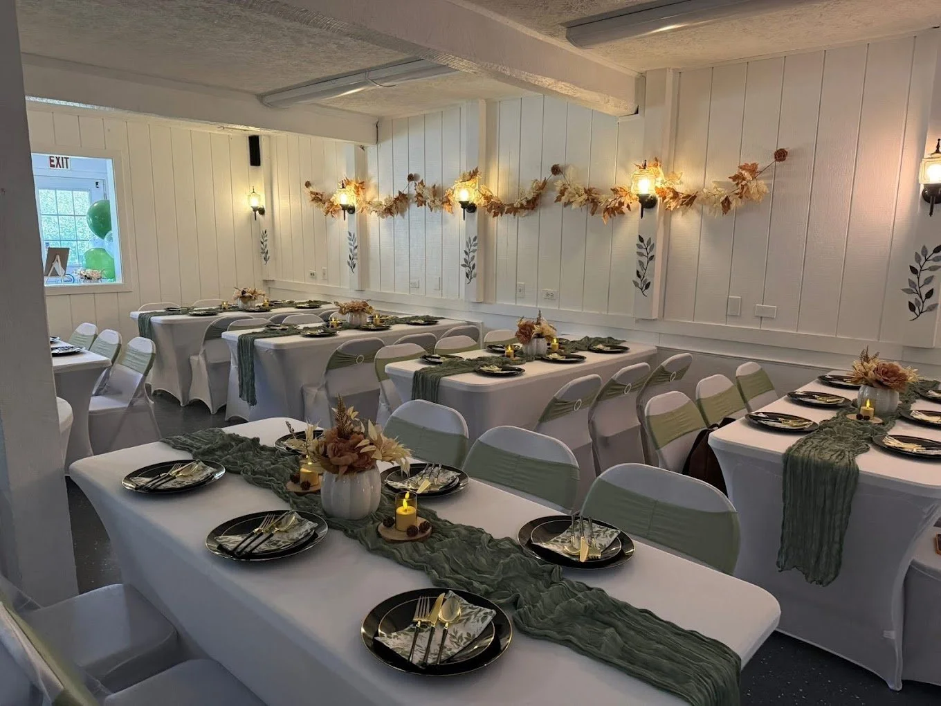 The Spot 757 main room set with white linens, sage runners, and black-rimmed plates