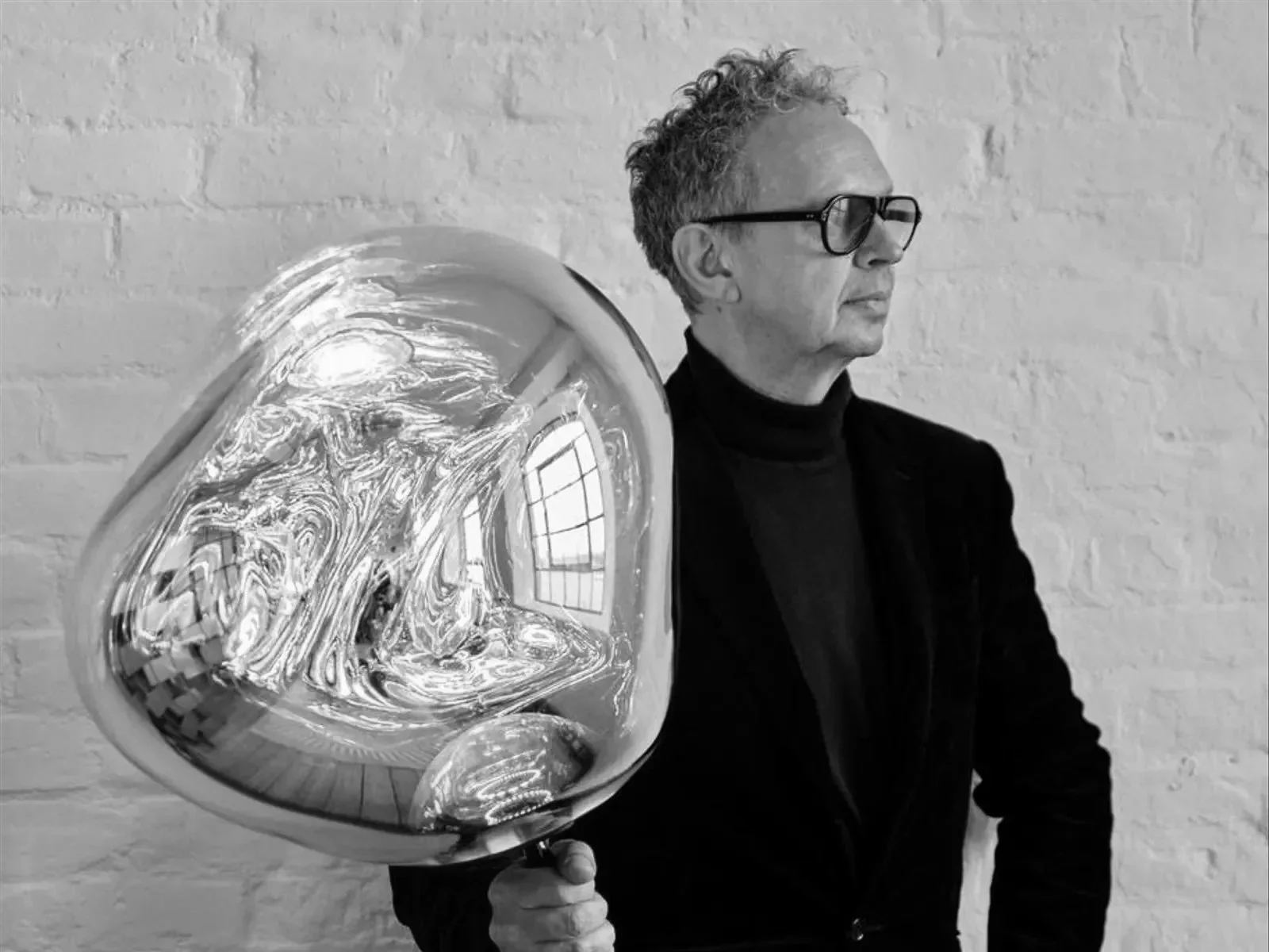 Portrait of designer Tom Dixon with one of his famous Melt Pendants