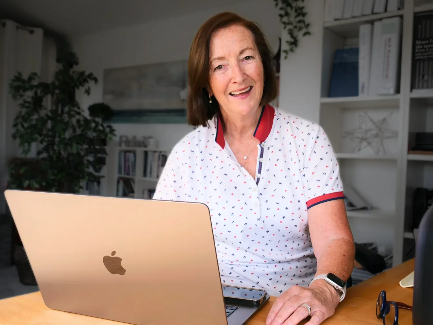 Julie Silfverberg web designer at desk with Apple laptop