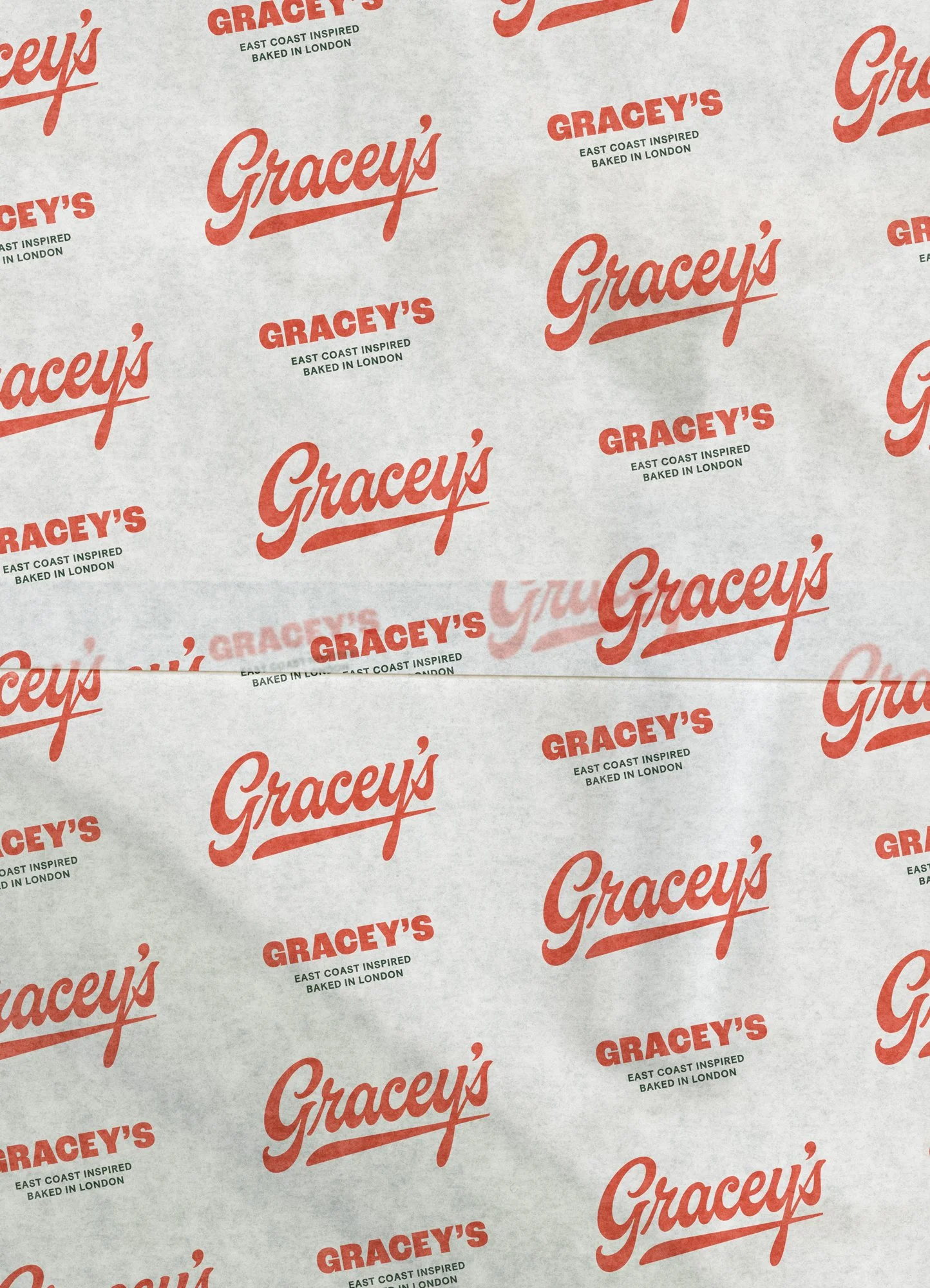 Patterned paper with repeated 'Gracey's' logo in red, along with the text 'East coast inspired baked in London'.