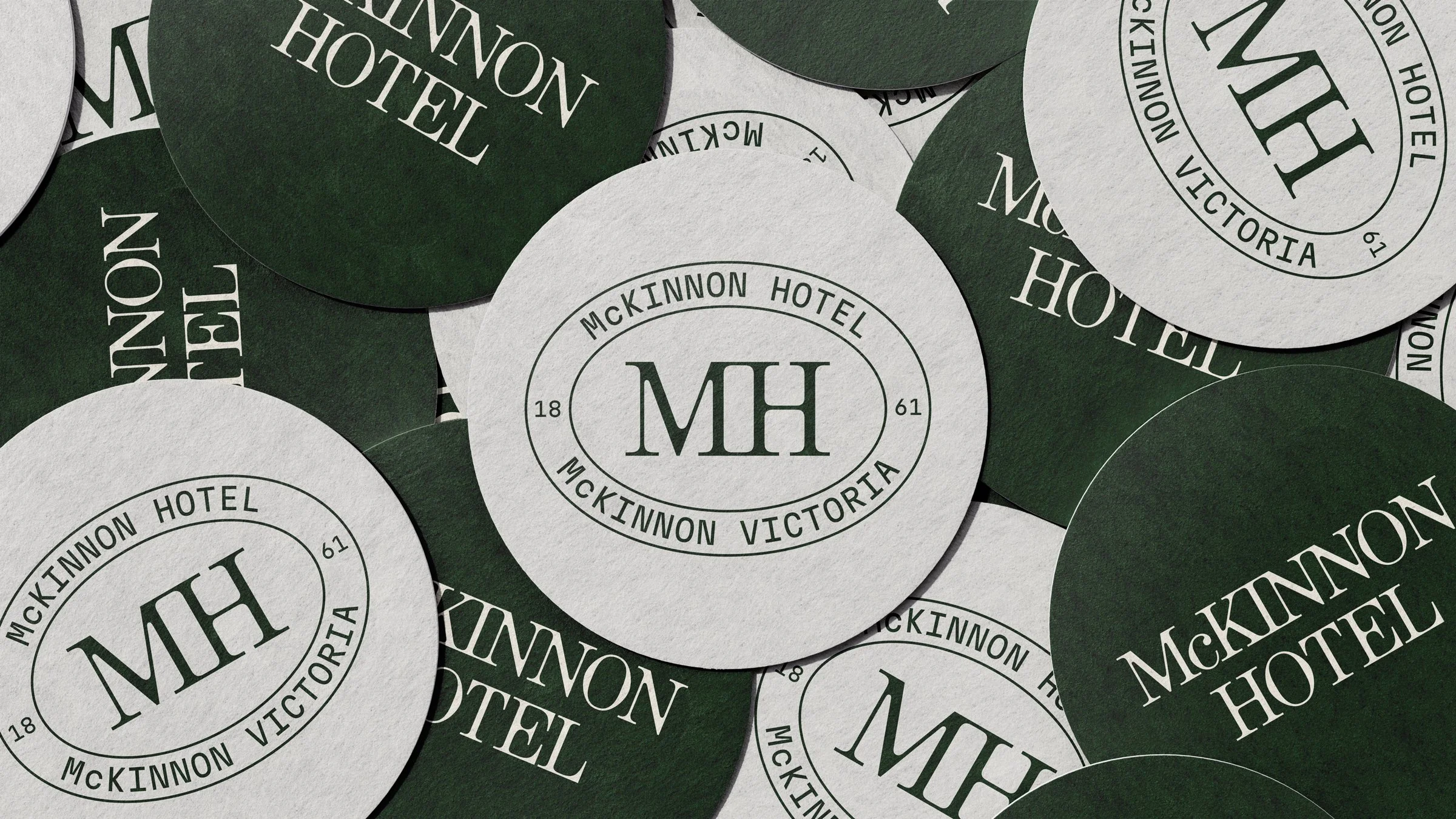 A bunch of McKinnon Hotel coasters messily spread out over a table.