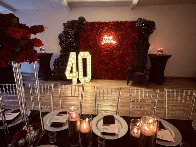 Red floral backdrop rental with black balloon arch and marquee 40 for a luxury event in South Jersey and Delaware.