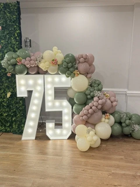 4ft marquee numbers 75 with organic sage and champagne balloon garland for a birthday in Philadelphia.
