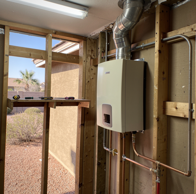 Stainless steel and PVC tankless water heater vent pipes side by side