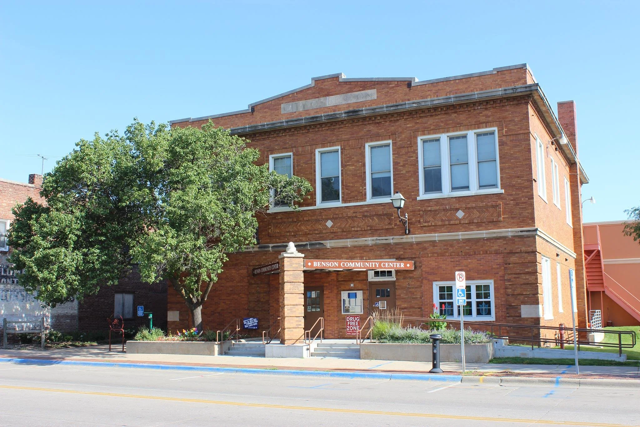 Benson Community Center red brick building with trees and parking signs
