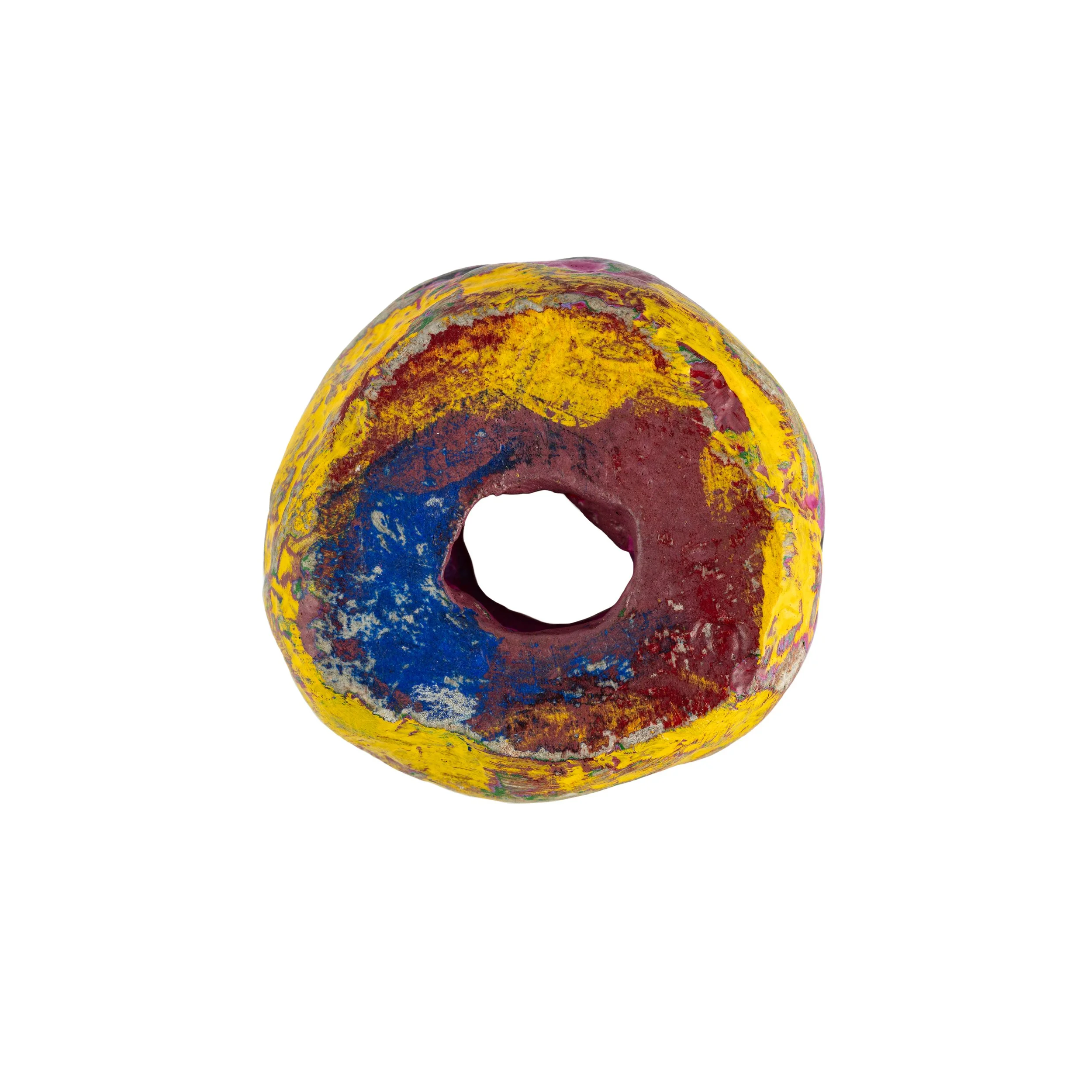 Colorful abstract sculpture resembling a round shape, with yellow, blue, and red paint, against a white background.