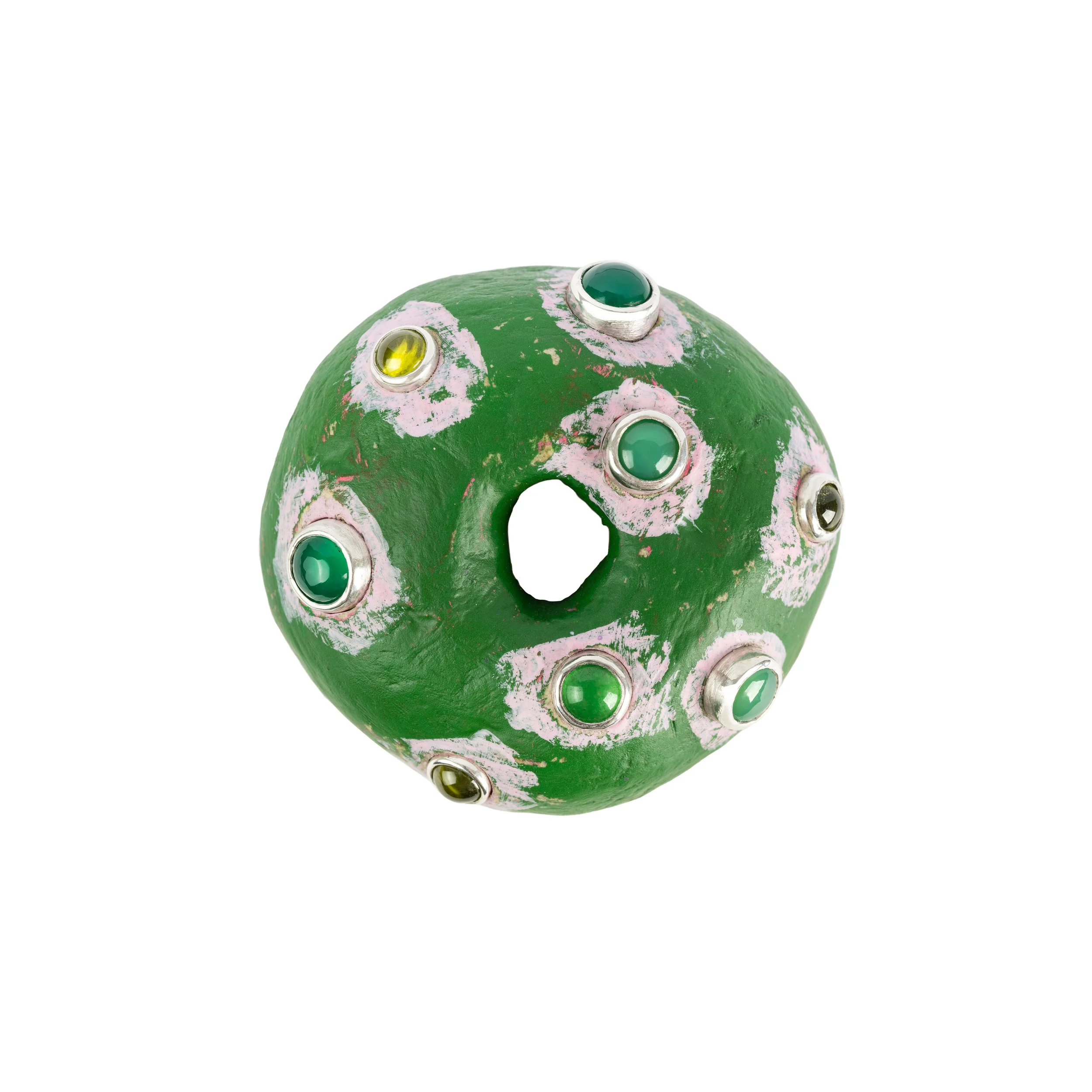 Decorative green ceramic ball with multicolored embedded gemstones and an opening in the center, isolated on white background.