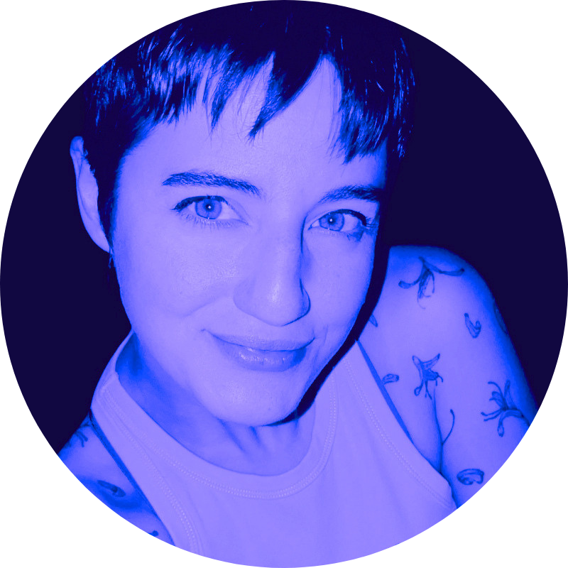 Phoebe C.  Photography smiling into trhe camera with her head tilted while sporting the cutest pixie cut hair.