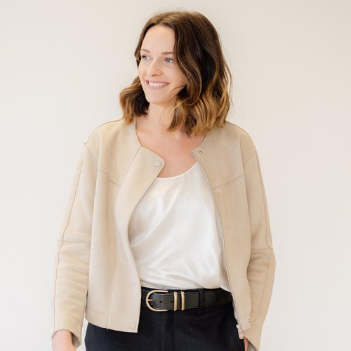 A smiling professional woman who is a branding expert and personal branding coach.