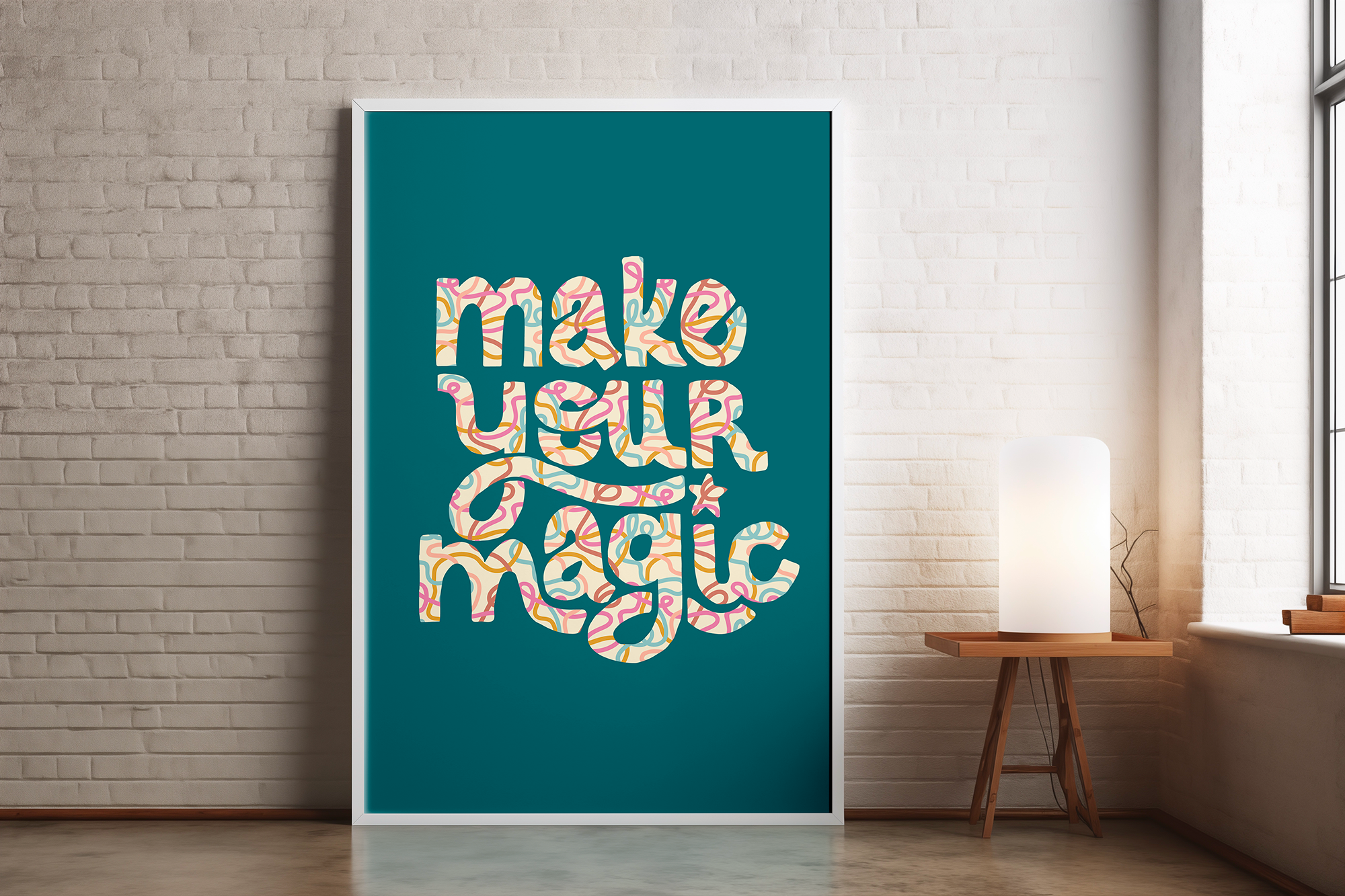 A framed modern art print with the phrase 'mind over matter' written in colorful, abstract, swirling patterns, hanging on a white brick wall in a well-lit room.