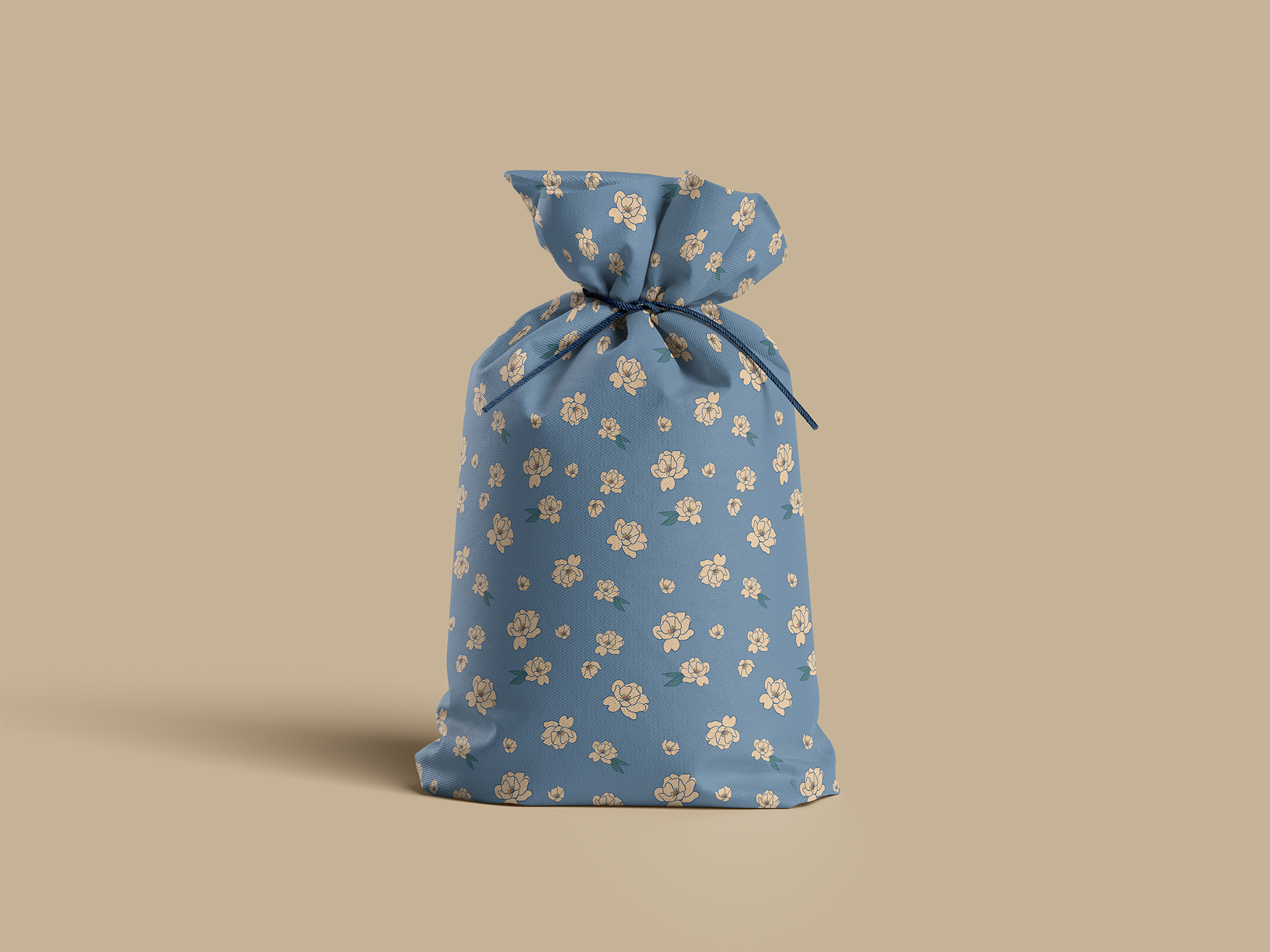 A fabric pouch with a blue background and a floral pattern, tied with a dark blue string.