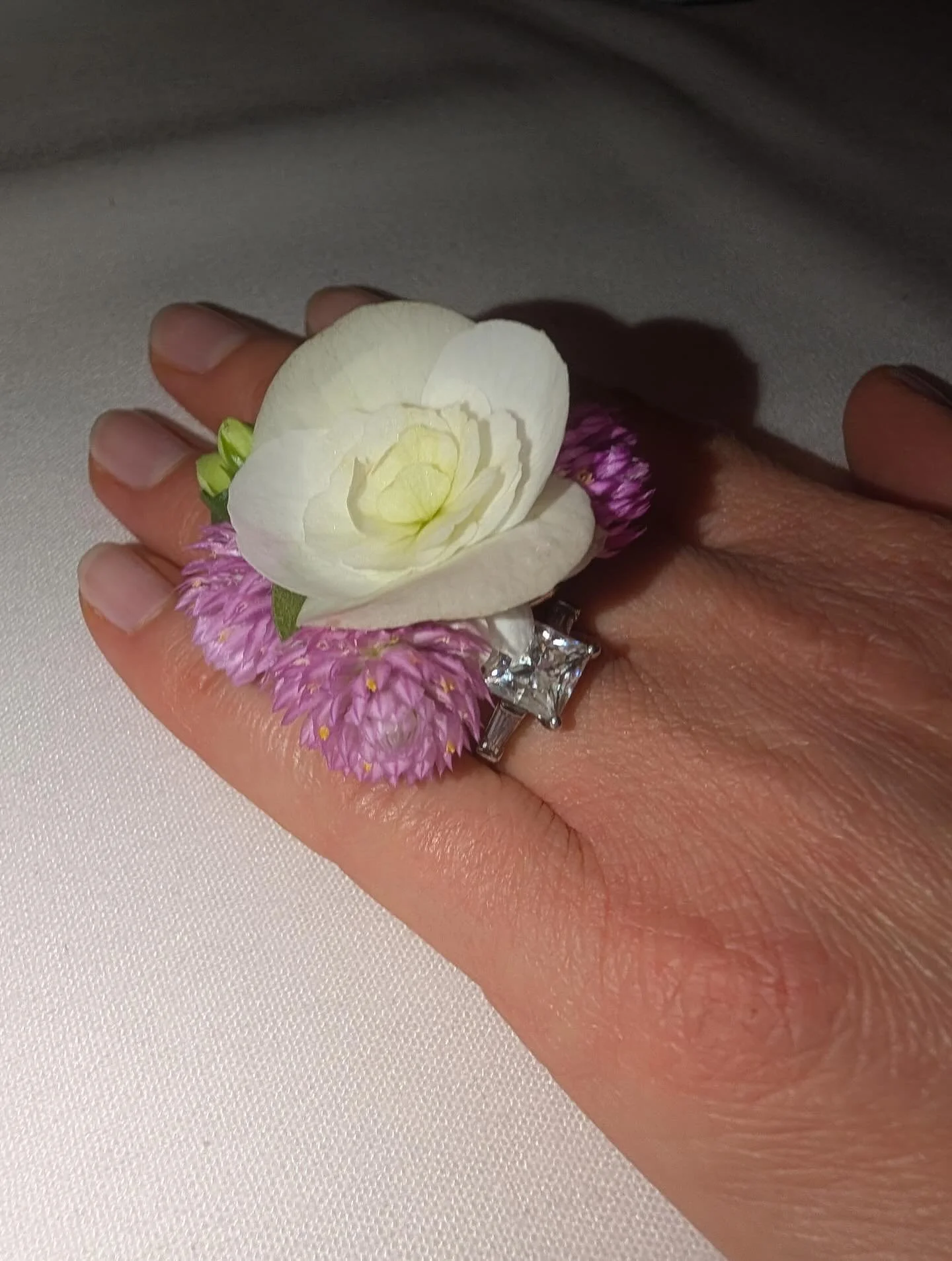 A gift for his fianc&eacute;e to wear on a special night out.  She loves purple so we used two shades of gomphrena as well as begonia, succulent, kalanchoe and boxwood- all homegrown .  Floral ring, mini arrangement 🩷