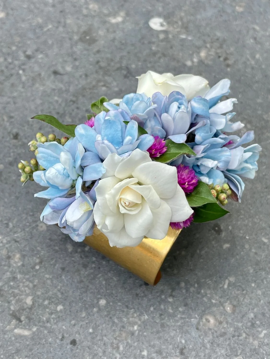 Tweedia Cuff paired with bottlebrush buds, garden roses, and gomphrena.