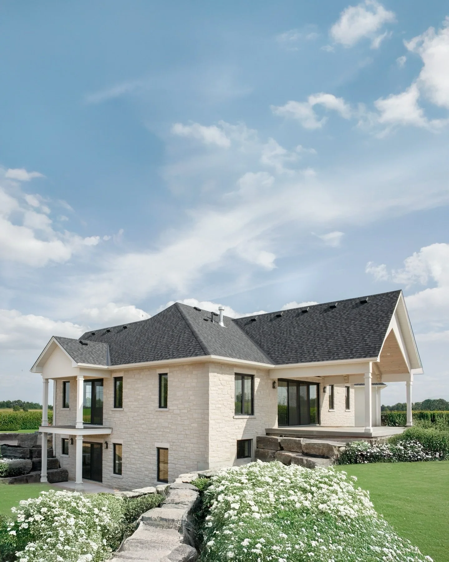 CLOVERFIELD FARMS | exterior

Roof @certainteed 
Windows @southfield_windows_doors 
Stone @arriscraftstone 
Stucco colour @farrowandball 
Paint: @farrowandball 
Exterior sconces: @quoizellighting
Hardware @baldwinhardware 
Stone @masonalstone 
Design