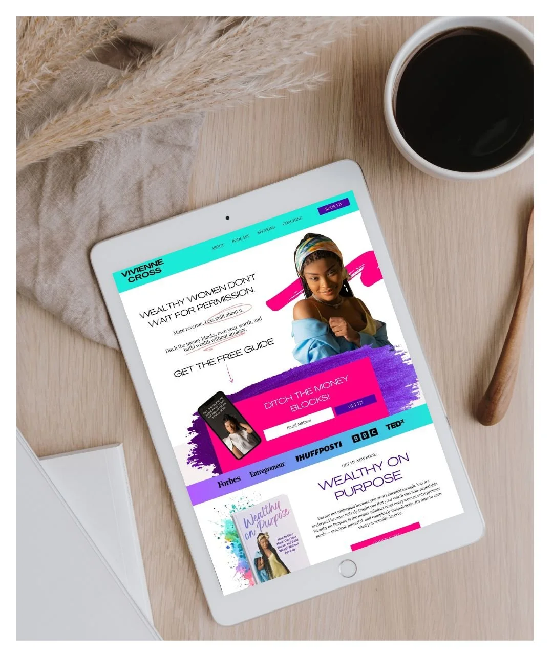 Neutral background image with a cup of coffee that shows an iPad with a colorful website of an abundance coach