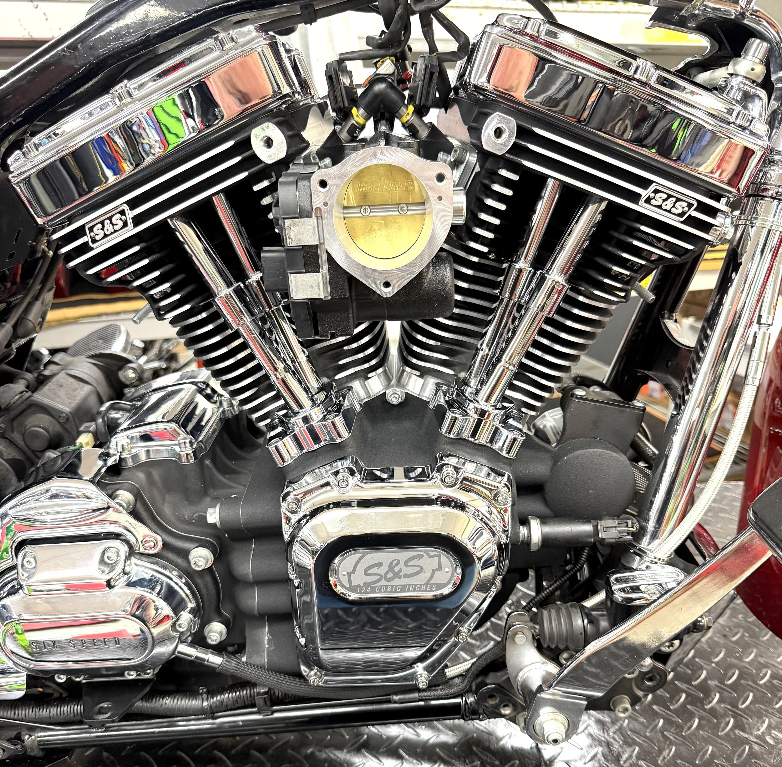 Close-up of a motorcycle engine with chrome details and a labeled component indicating 124 cubic inches.
