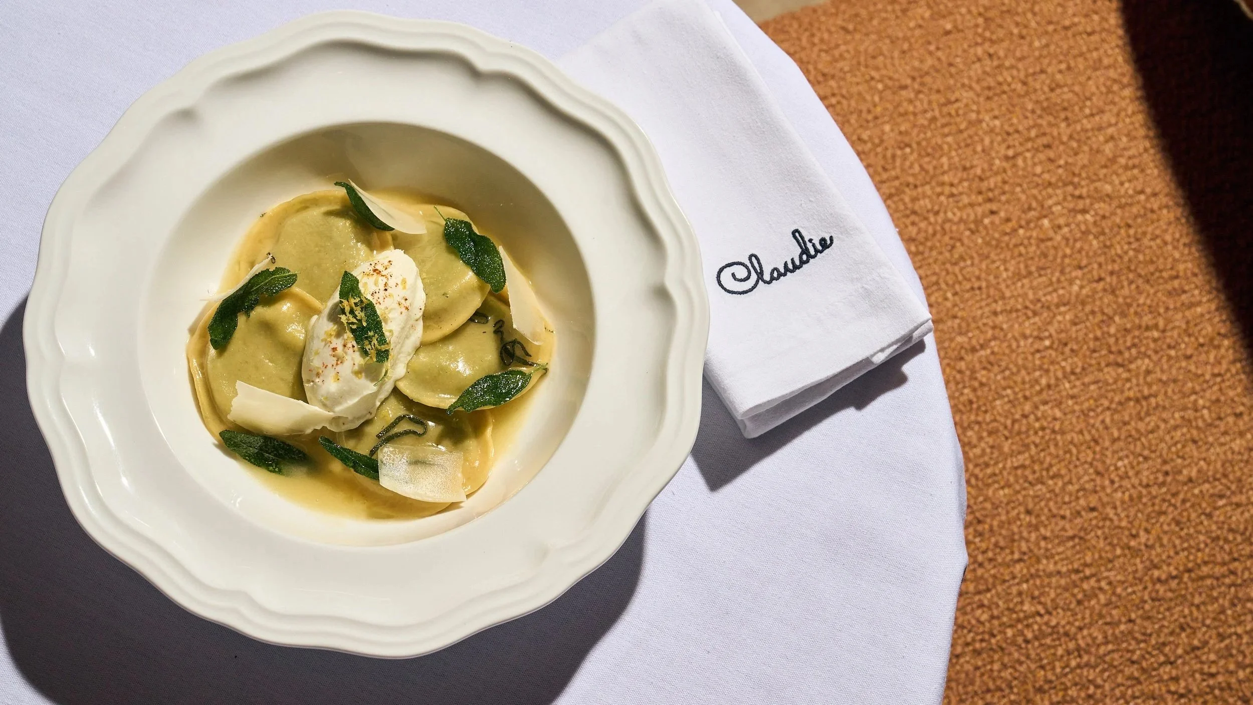 Ravioli dish on the Claudie Menu garnished with spinach. 