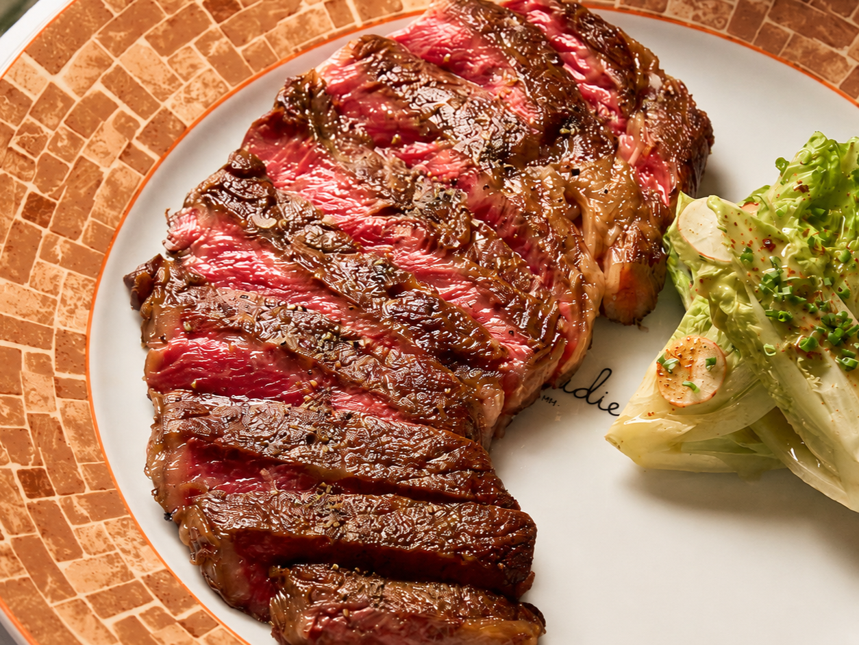 A perfectly cooked steak cut on a plate, served as a dish for Father's Day Brunch at CLAUDIE restaurant