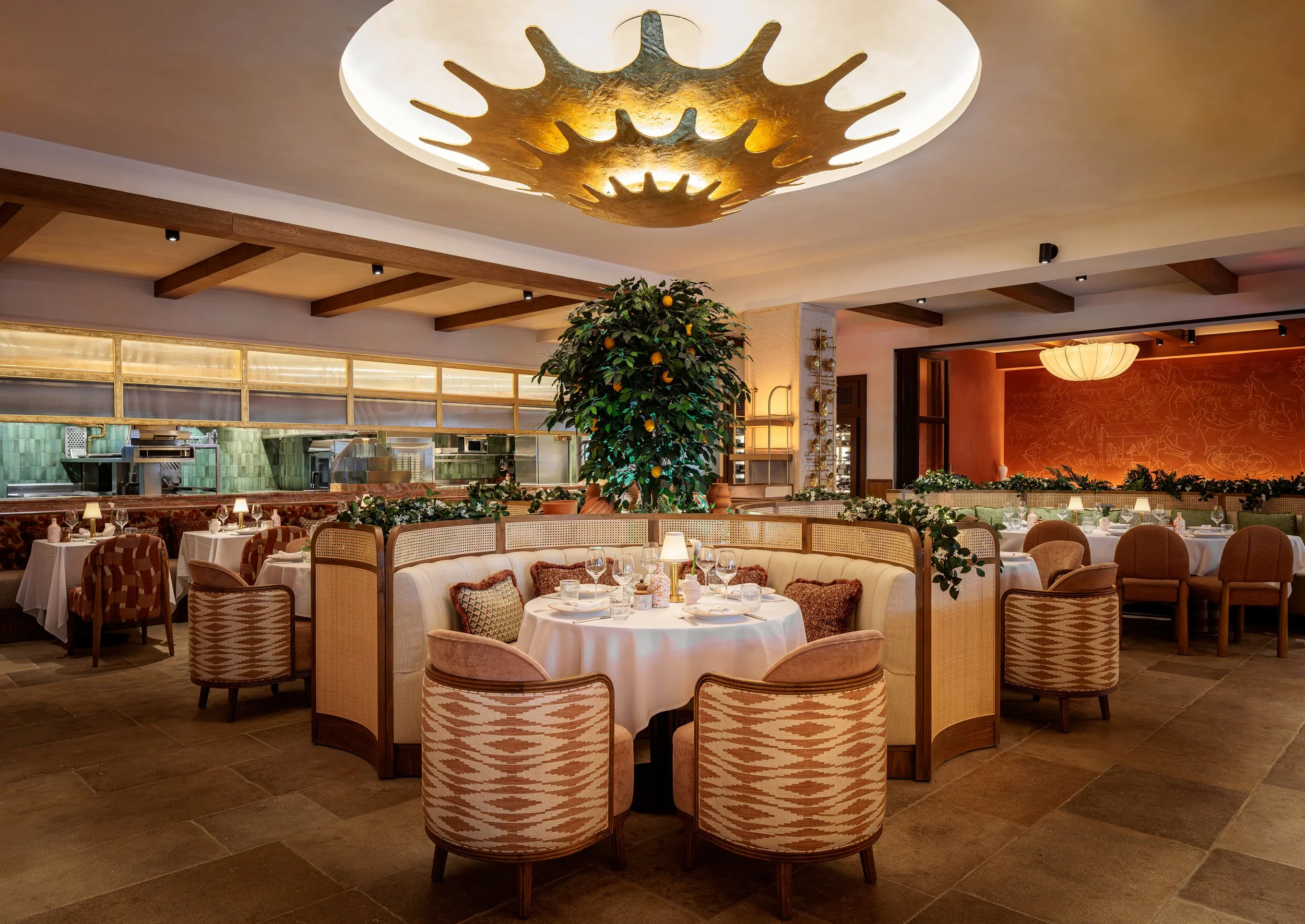 CLAUDIE's interior dining room with an orange tree in the middle of tables.