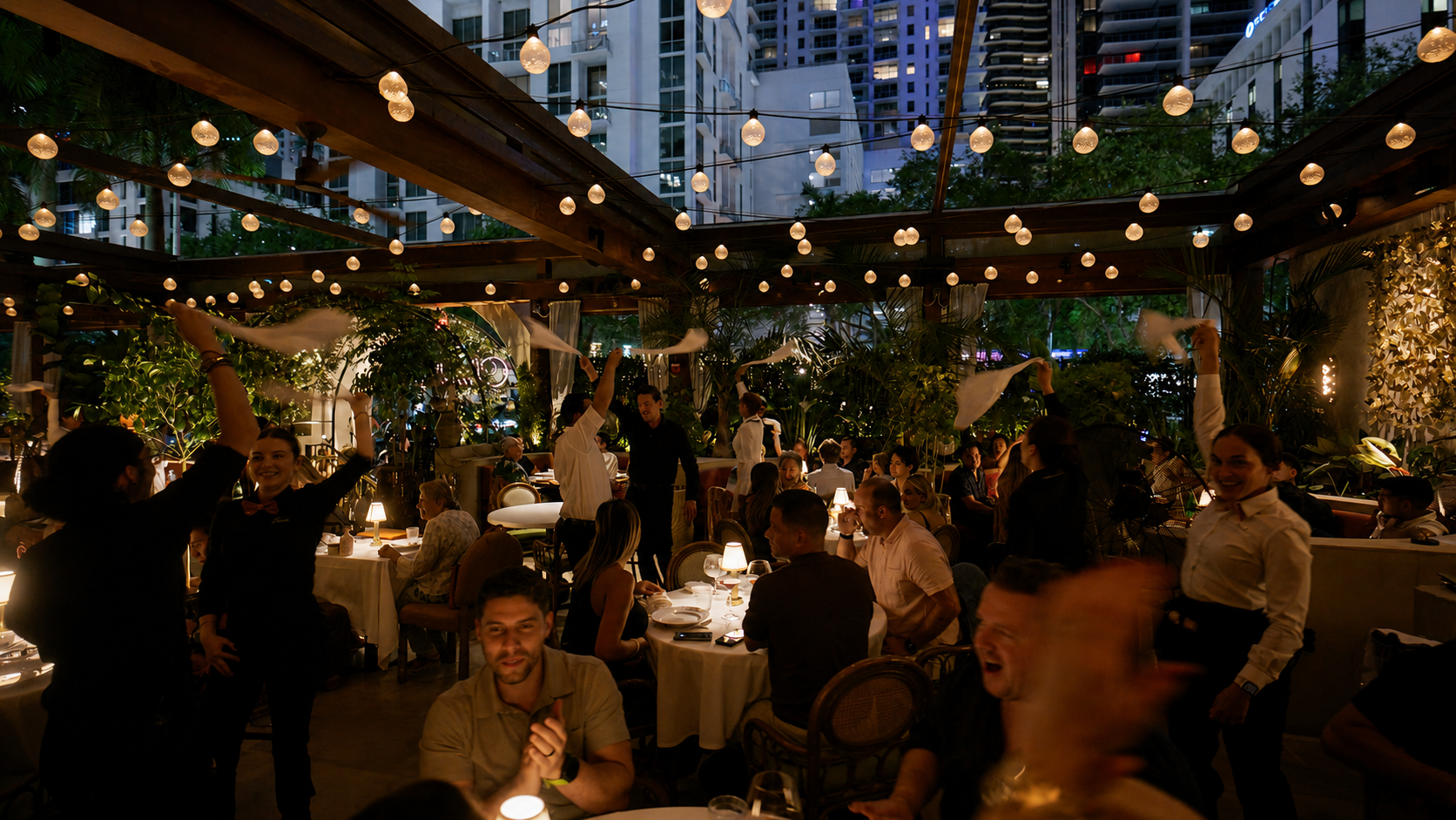 CLAUDIE's atmosphere at the night time, with the servers doing the napkin toss celebration.