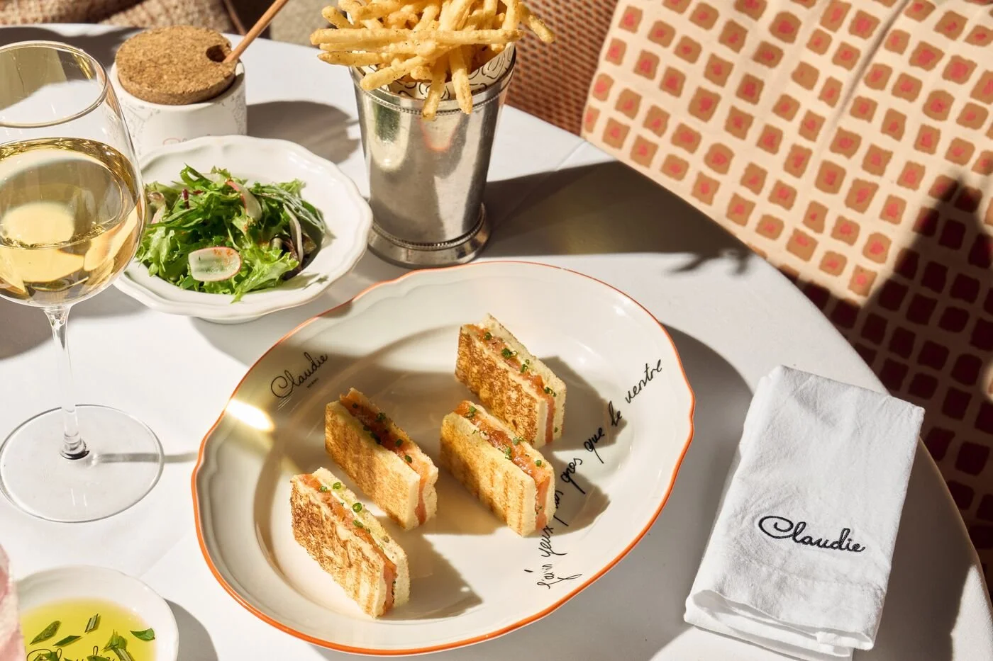 The Smoked Salmon Toast with a side of fries, a salad and a glass of wine.