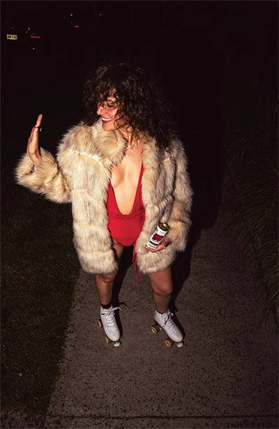 Woman roller skating with Good Liar American non-alcoholic IPA can