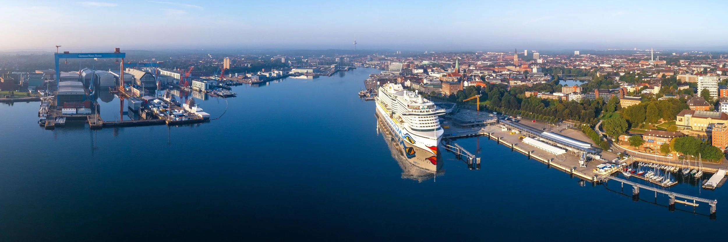 Aerial view of the port in Kiel showing industry area, a ship and a small town with buildings