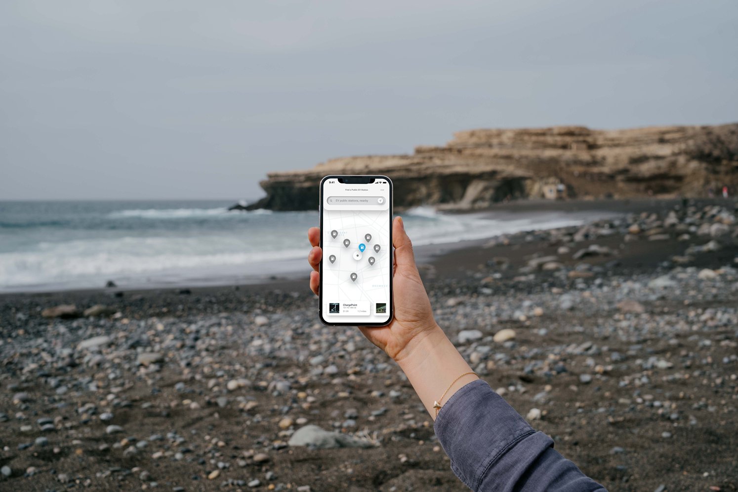 mockuuups-iphone-13-pro-mockup-held-by-a-user-against-the-ocean.jpeg