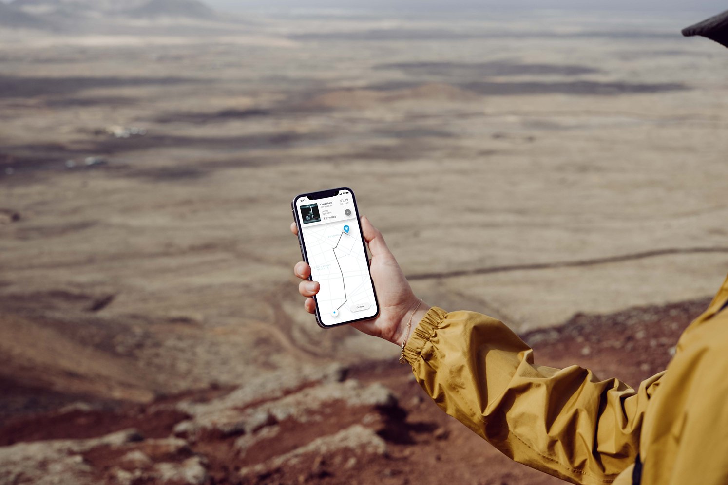 mockuuups-iphone-13-pro-mockup-held-by-a-user-over-a-large-field.jpeg