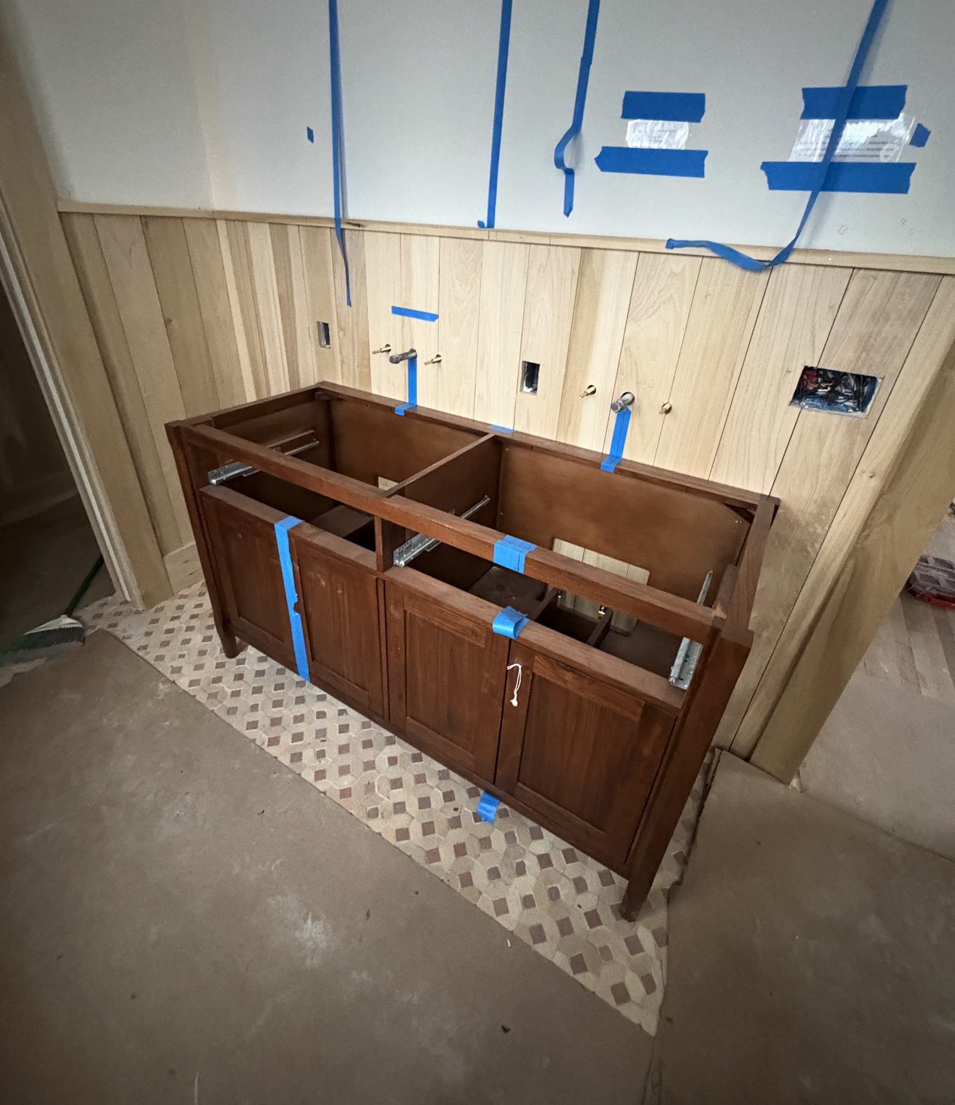 The Elizabeth Victorian-style home addition. Mid-project construction showing a partially assembled wooden kitchen cabinet 