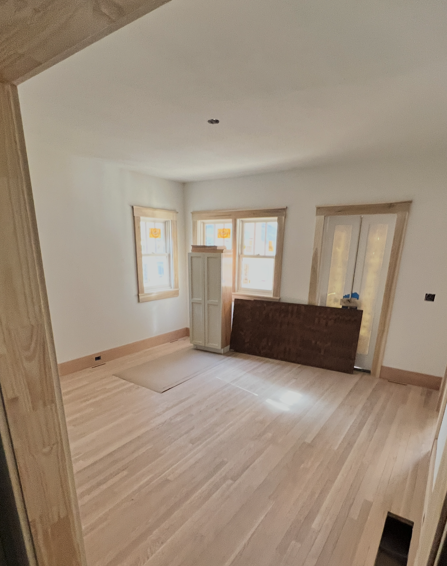 The Elizabeth Victorian-style home addition. Mid-project construction showing empty room and hardwood floors.