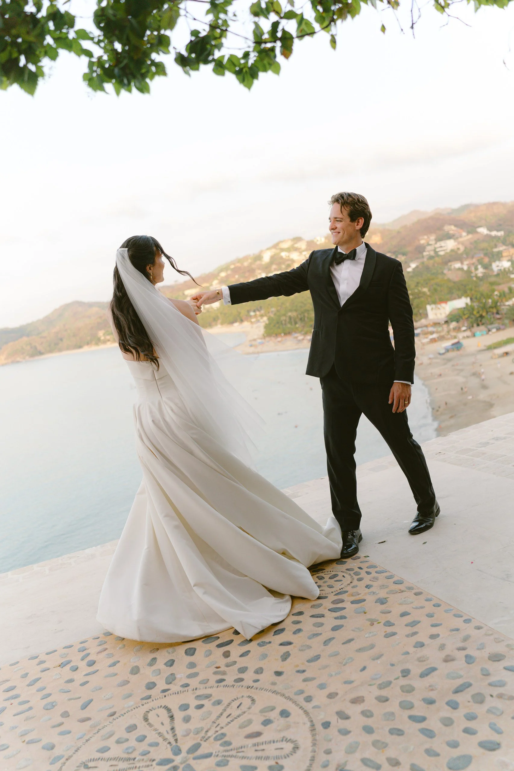 Newlyweds dancing at sunset with ocean views at Gran Villa, Sayulita
