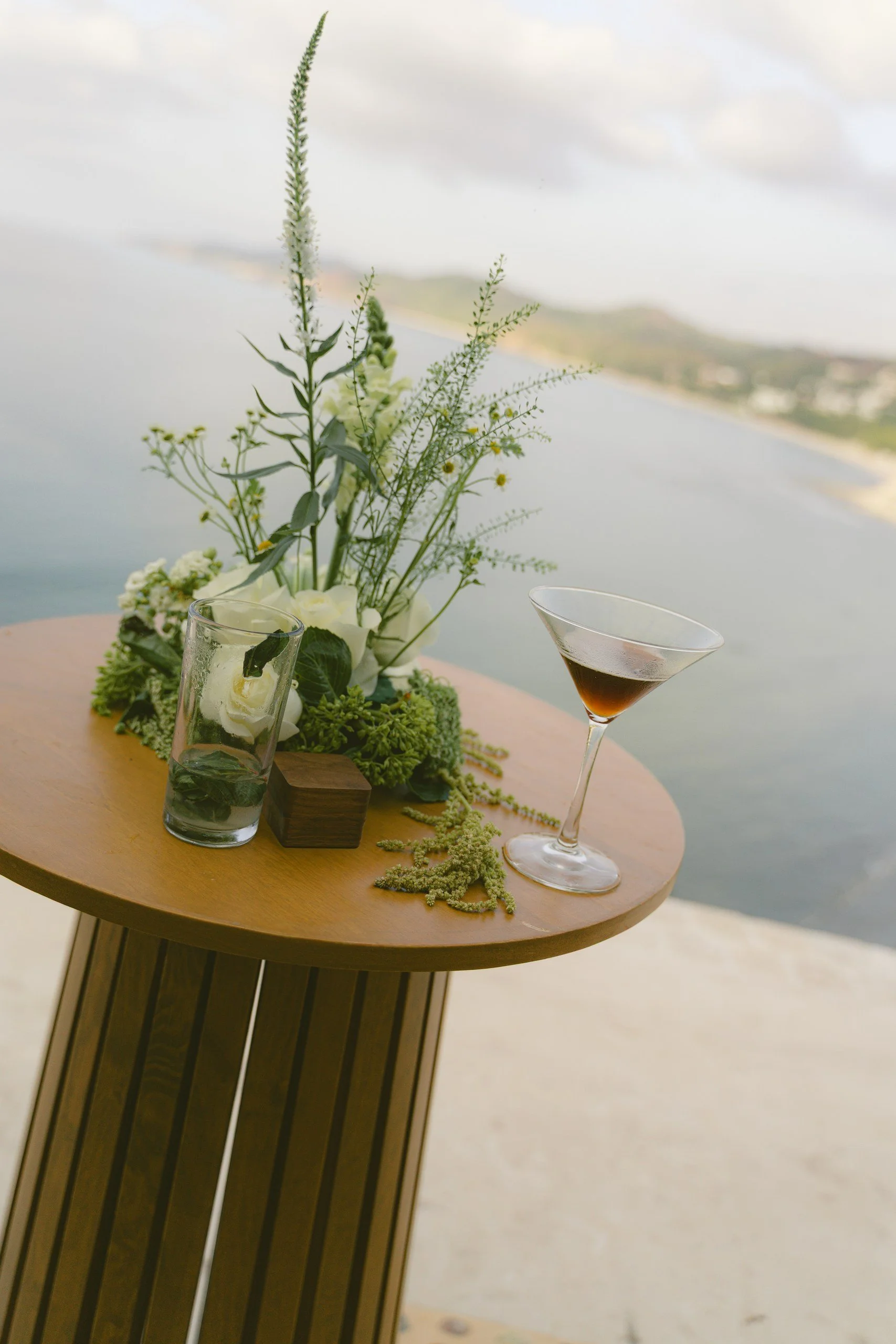 Cocktail table with floral centerpiece overlooking the ocean at Gran Villa, Sayulita
