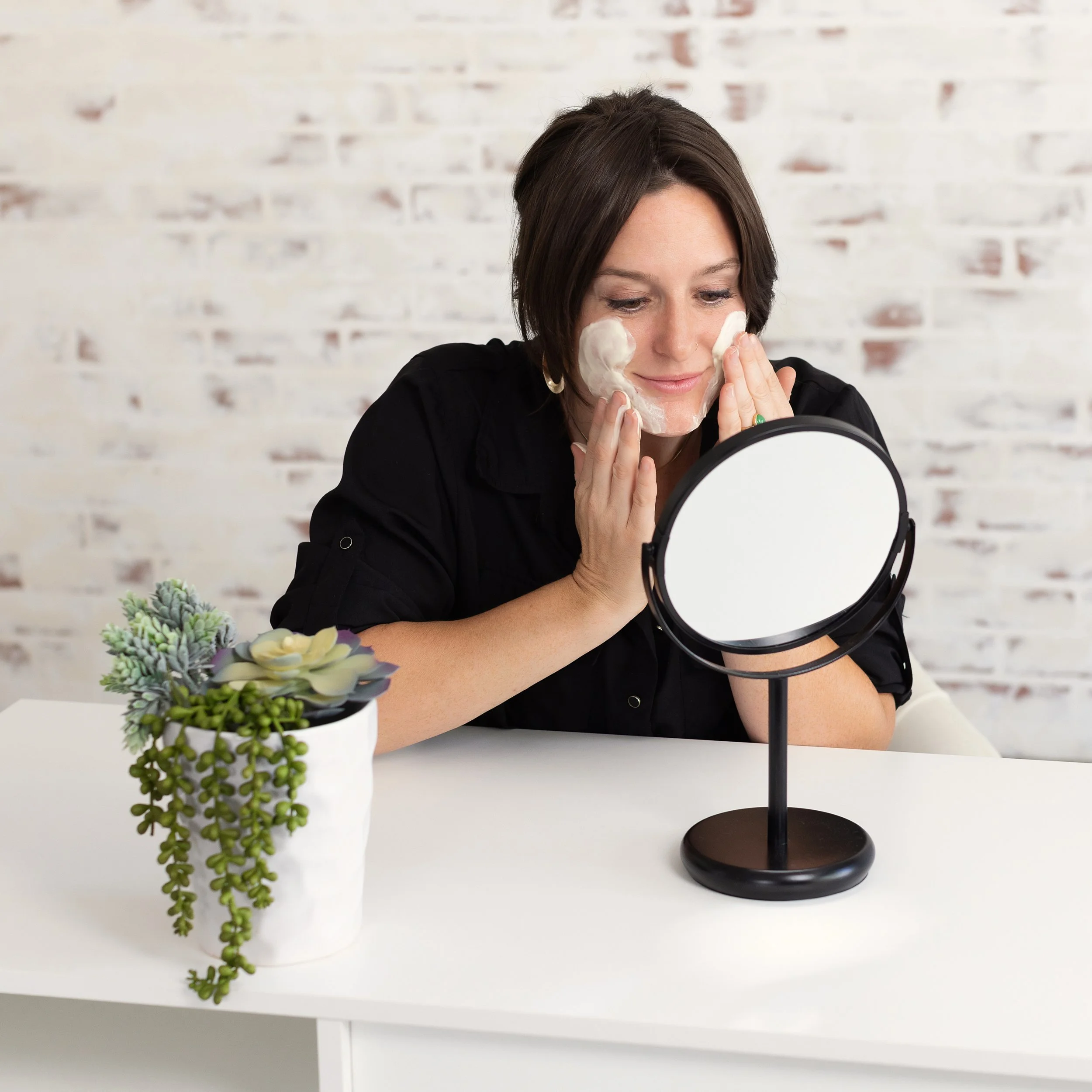 Woman applying skincare product to her face