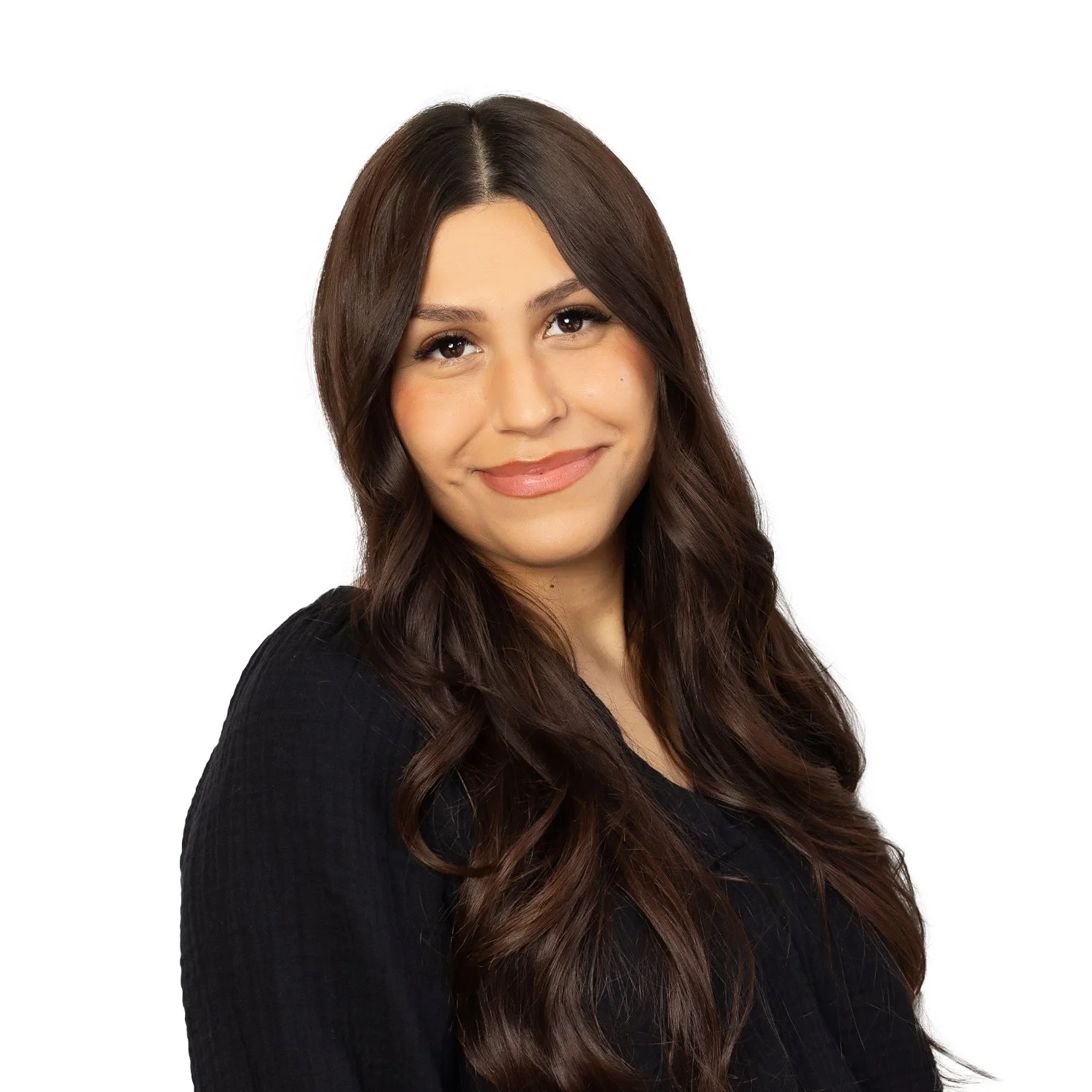Smiling woman with long wavy dark hair wearing a black top against a white background.