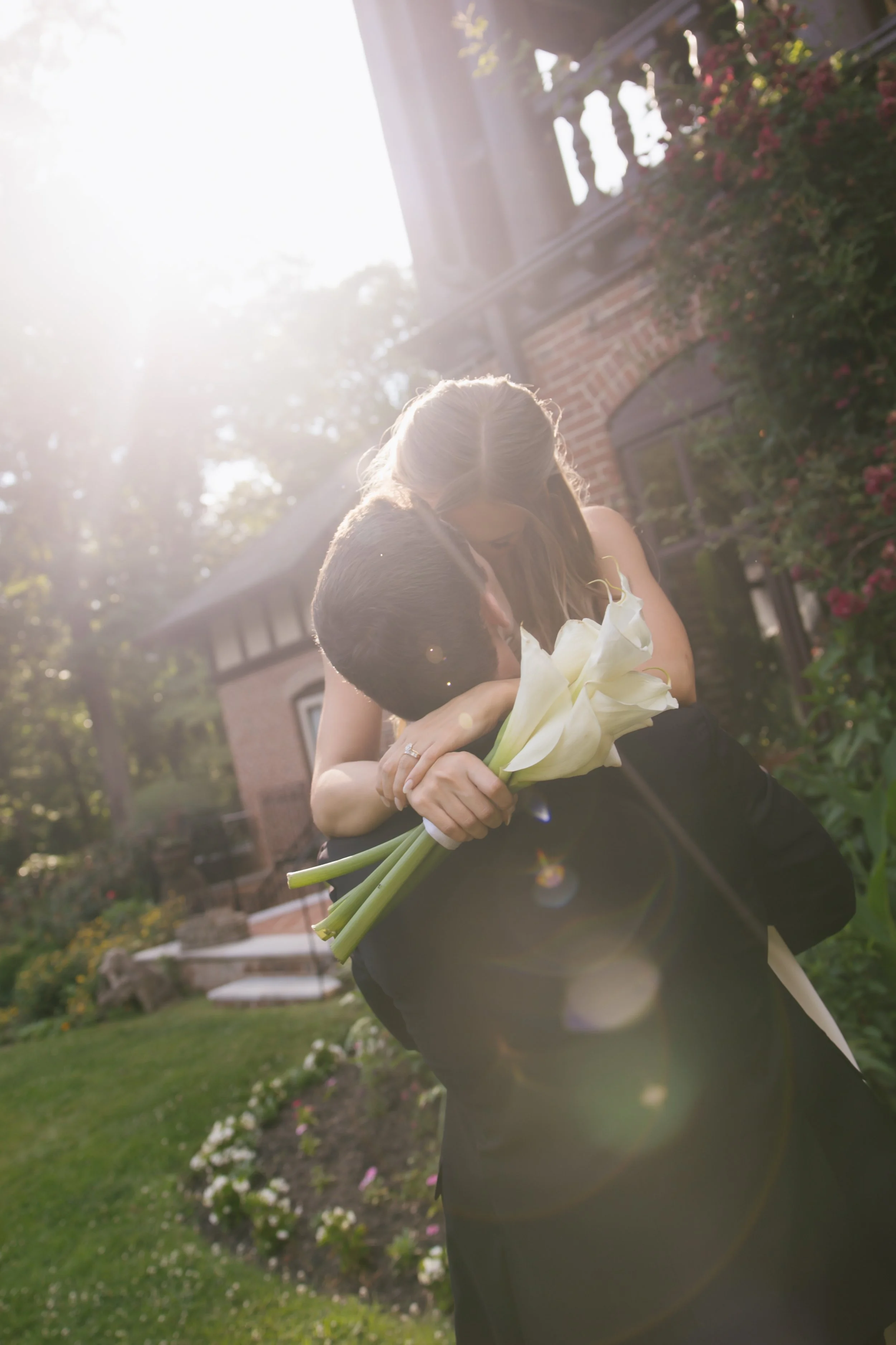 Tessa and Andrew Kissing with Modern White Calla Lily Bouquet.jpeg