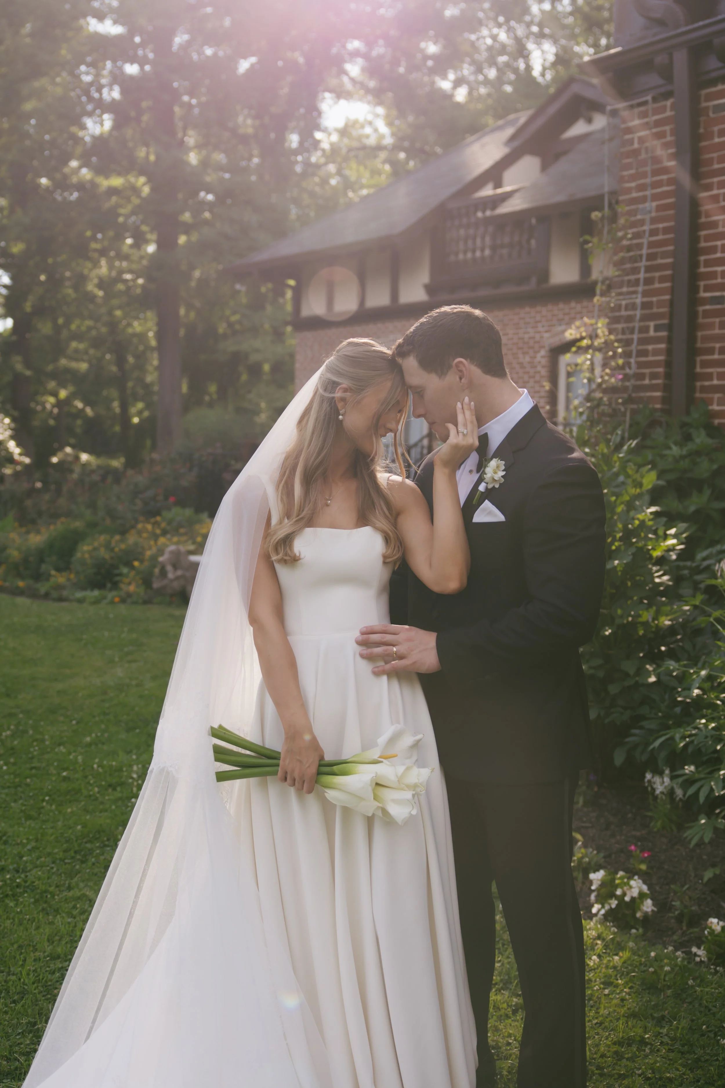 Tessa & Andrew Affectionate Shot with Modern Calla Lily Bouquet.jpeg
