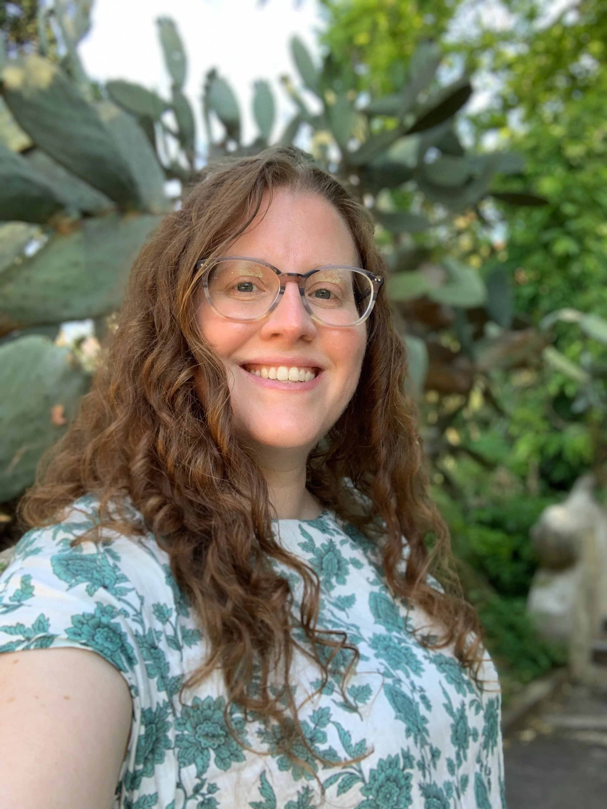 Portrait of Sarah, the artist, in a lush cactus garden