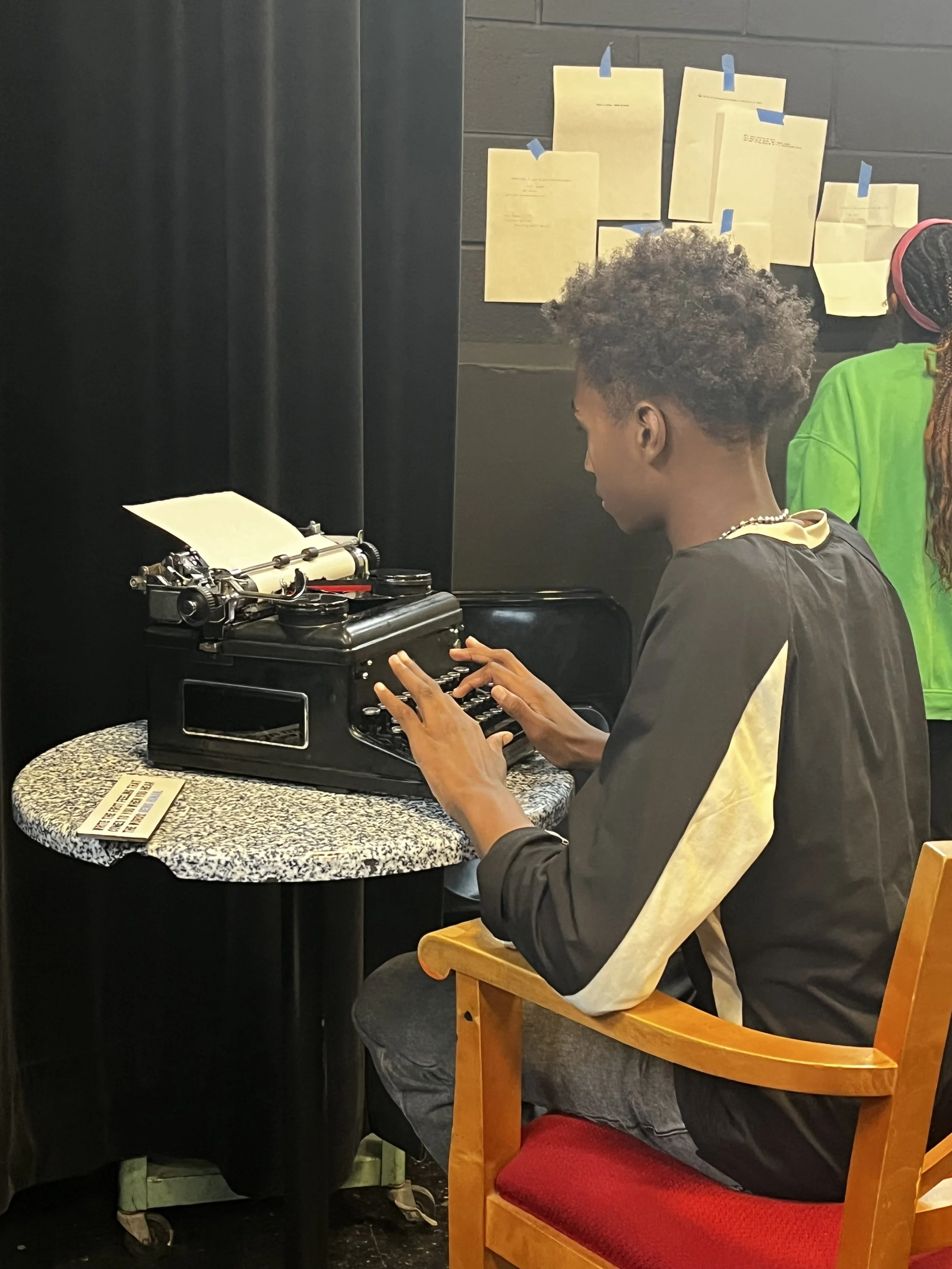 Student typing on typewritert