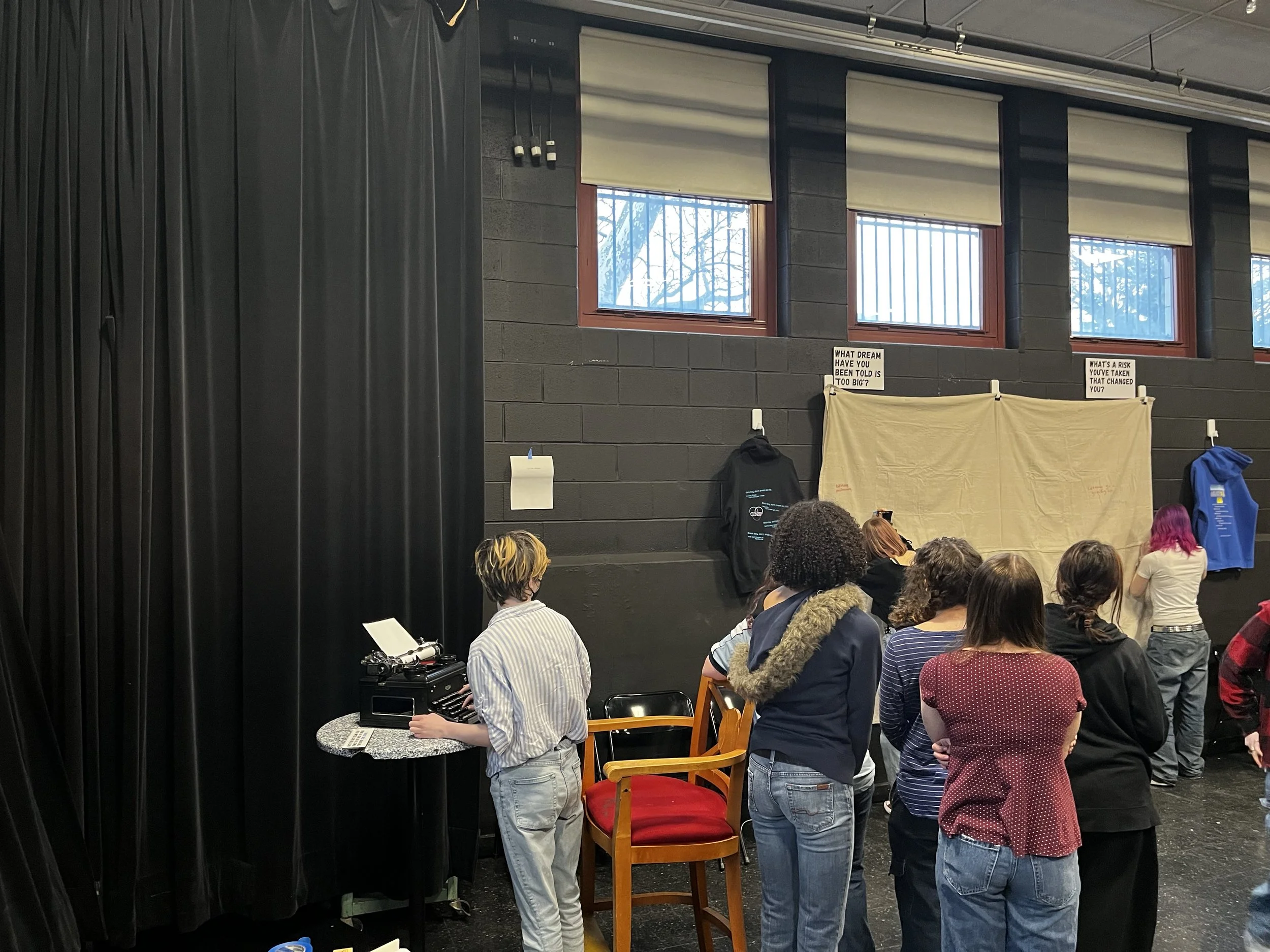 CAPA students interacting with typewriter and watching students write on textual tapestry