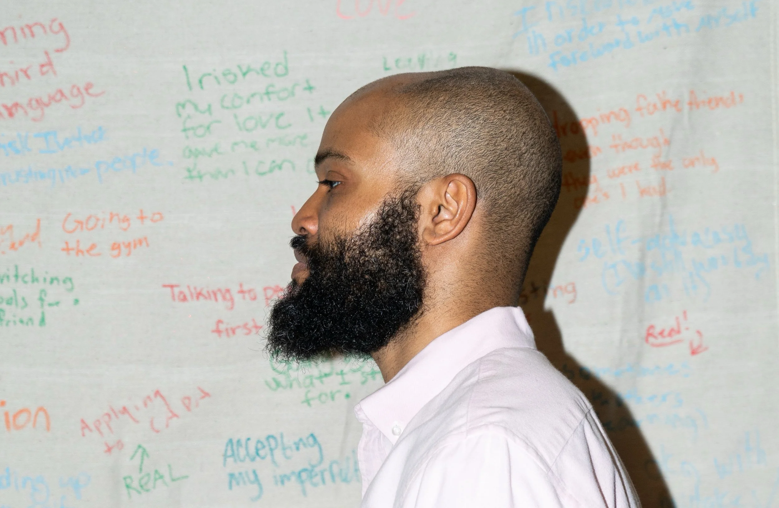 Armstead, profile photo, in front of Textual Tapestry