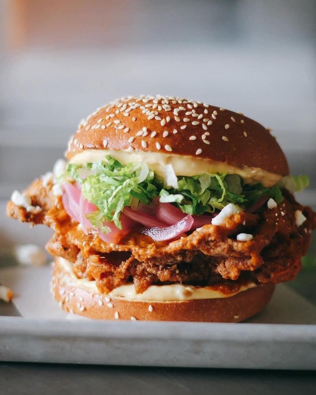 Haaaaaaaave you met the Tikka Clucka? Available every day at Honey&rsquo;s, this Indian-influenced hybrid combines our signature craggy fried chicken thigh, doused in creamy Tikka Masala sauce and finished with garlic achaar aioli, pickled red onions