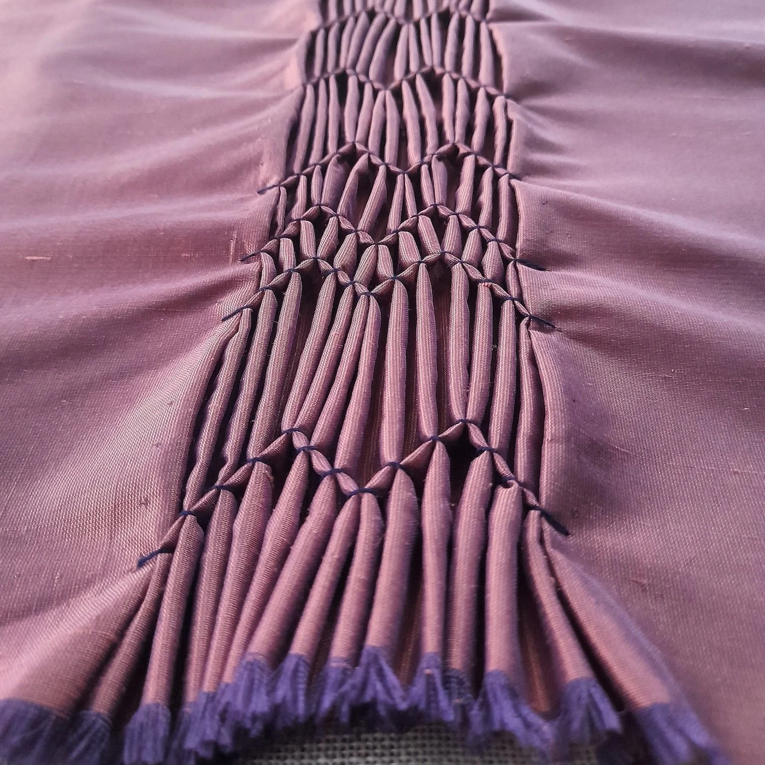 Smocking detail (silk fabric, cotton thread)