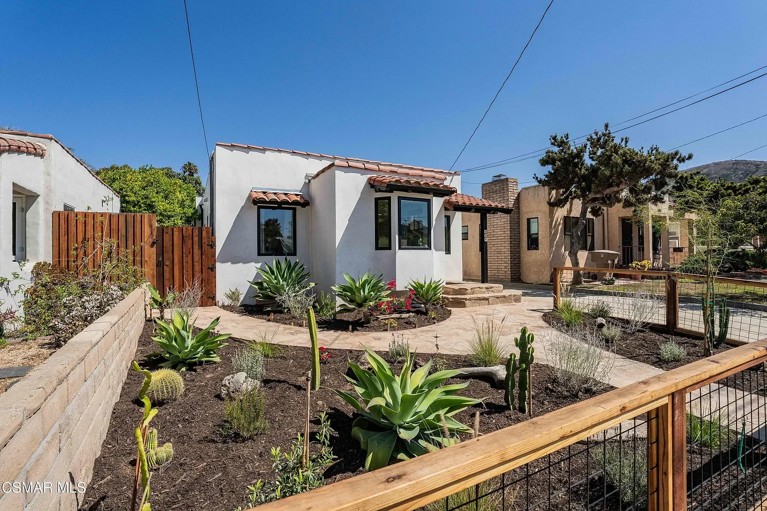 Mediterranean landscaping as well as a wire mesh fencing feature added botanical vibes and a container to elevate the overall look. 