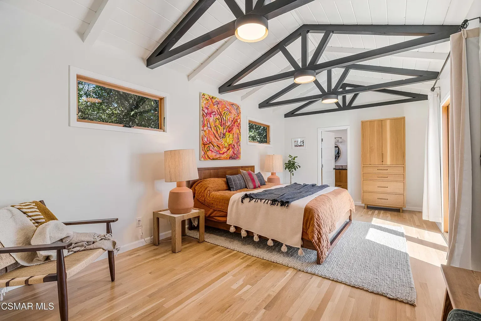 An existing  master suite was refreshed with vaulted ceilings, a custom furniture piece, and an expansive master bath with direct access to the private patio via French double doors.