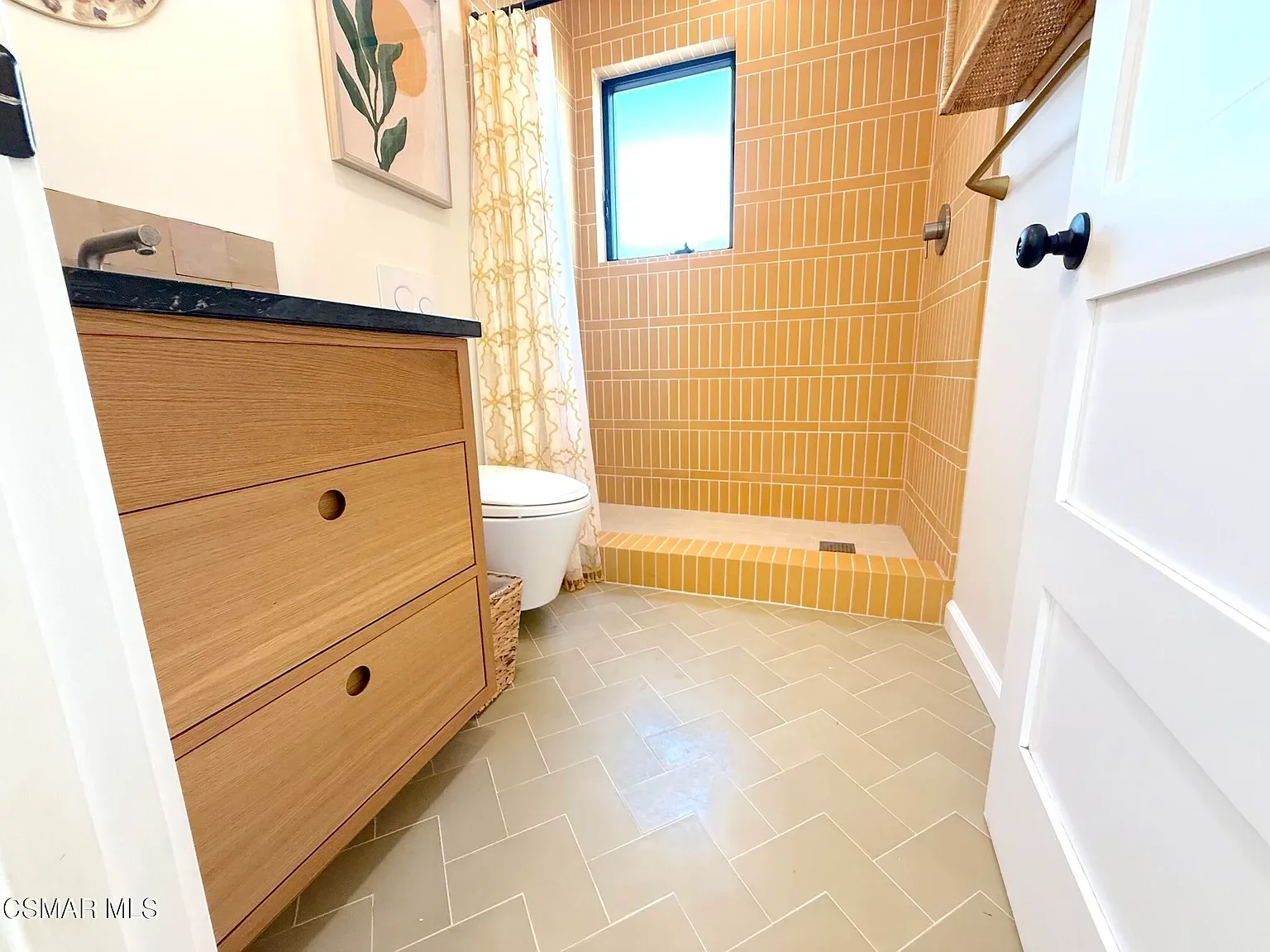 Guest bath: custom cabinet with cement tile flooring (arrow pattern/Zia) and porcelain tile in a straight stacked brick pattern. The colors bring in a California Superbloom vibe in a wild meadow. 