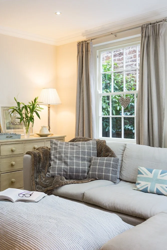 cosy reading nook below large sash window 