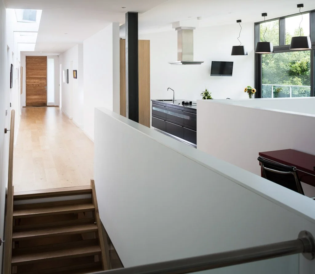 modern landing with glimpse to kitchen and views outside