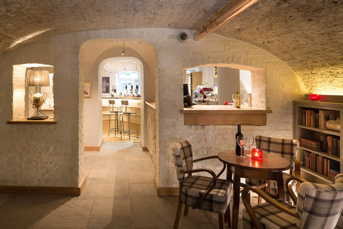 cellar restaurant area with arched doorway looking through to bar