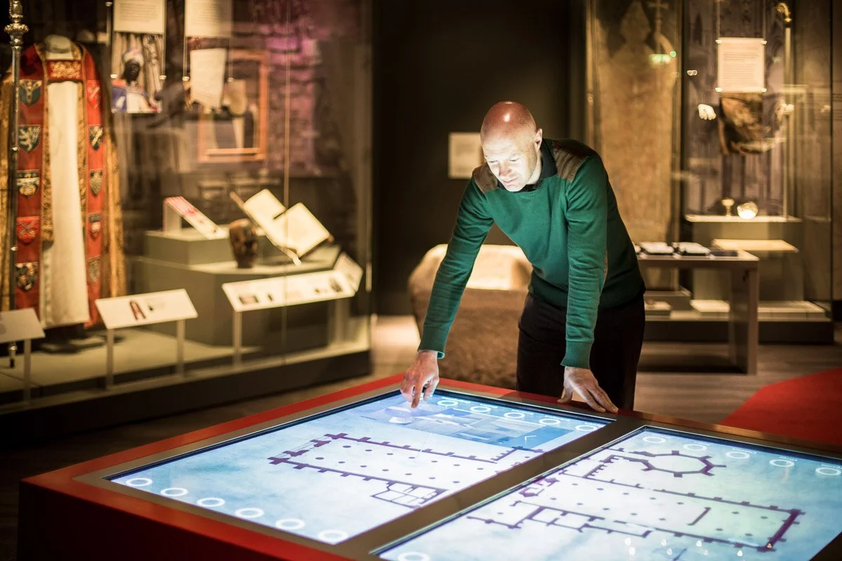portrait of man looking over large plans of york minster